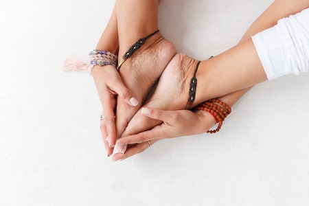 Lotus pose, yoga hands close up. Yoga woman in white sport clothes meditation. Young woman relax and...