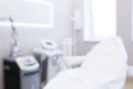 Industry of beauty. An empty procedural office in cosmetology clinic with professional chair. Medical and beauty concept. Blurrred imageの写真素材