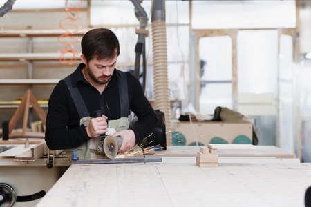Industrial worker cutting metal with many sharp sparks. Selection focus to cutting machine. Copyspace. Place for the text.の写真素材