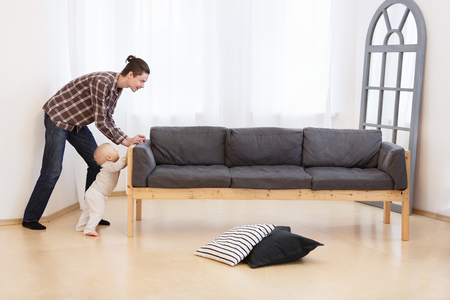 Smiling stay-at- home dad spending time together with his little child, do the cleaning on the housee. Home, housekeeping concept.の写真素材