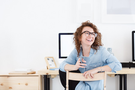 Pretty overjoyed female in casual clothes being glad to be promoted at work, smiling happily, celebrating success with Ñolleaguesの写真素材