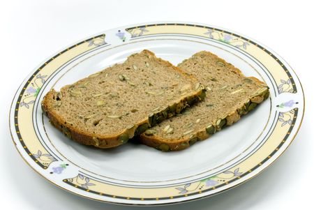 wholegrain bread with sunflower seeds on white background