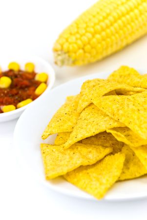 Glass bowls of salsa - dip and tortilla chips in kitchen or restaurant