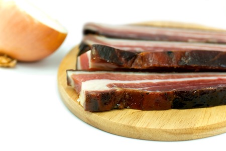 Slices of smoked Bacon on the wooden Board