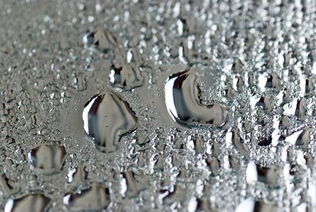 brushed silver metallic background with silvery bubbles or dropsの写真素材
