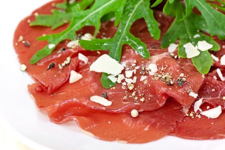 Beef carpaccio with pepper, rucola and parmesanの写真素材