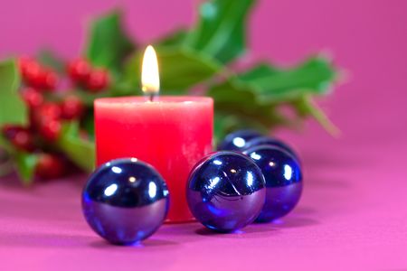 christmas decoration with candle light,holly leaves and berriesの写真素材