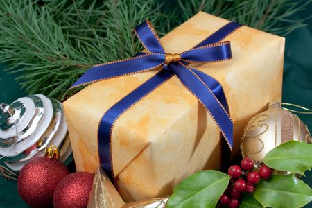 christmas gift with bauble and holly