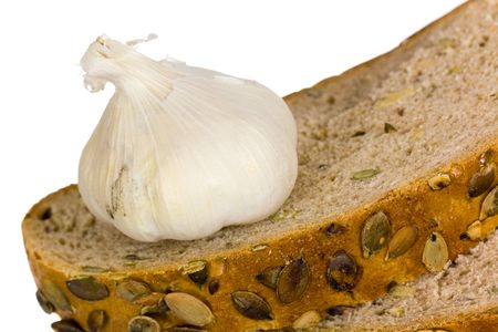 Garlic head detail isolated on white background and breadの写真素材
