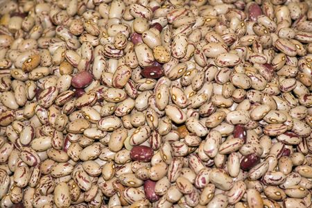 Heap of dried red haricots close-up as background.