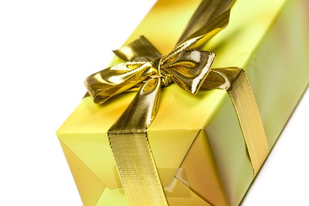 Gift box and golden ribbon, isolated on the white backgroundの写真素材