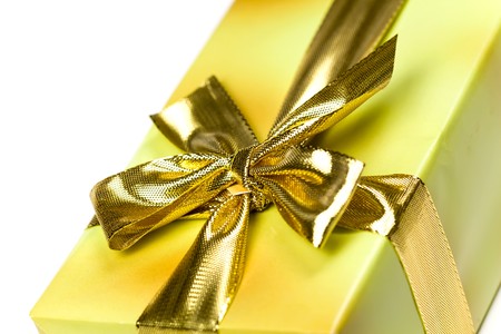 Gift box and golden ribbon, isolated on the white backgroundの写真素材