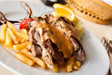 Stuffed steak with ham,cheese and french fries の写真素材