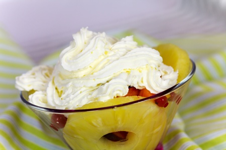 Delicious fresh fruit salad served in bowl as dessert,whipped creamの写真素材