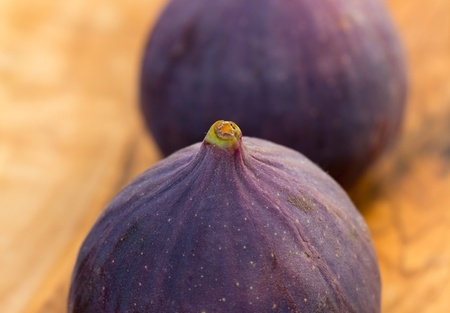 Ripe figs on wooden background の写真素材