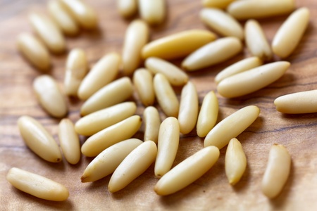Ripened pine nuts on a wooden background の写真素材