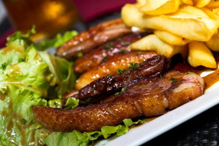 Close up , Roasted duck , french fries, potatoes, caramelized, and Salad の写真素材