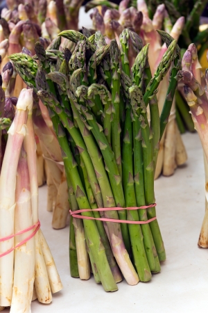 Bunch of fresh asparagus on wooden tableの写真素材