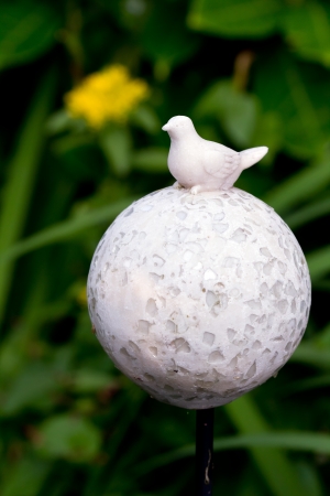 Sculpture of Bird and Ball in the Gardenの写真素材