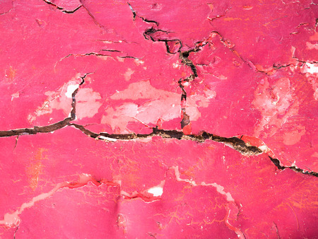 The red surface of the building is cracked abstract background.