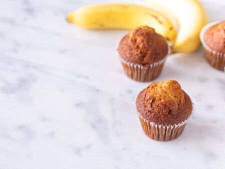 Top view close up brown muffin or banana cake on white table background for breakfast in morning day.の写真素材