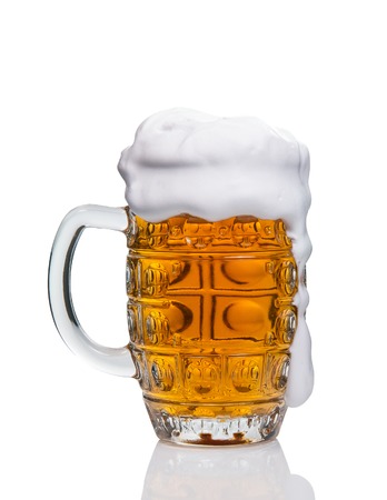mug of fresh cold beer with foam on white backgroundの写真素材