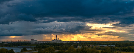 panorama of great sunset above power plant summer eveningの写真素材