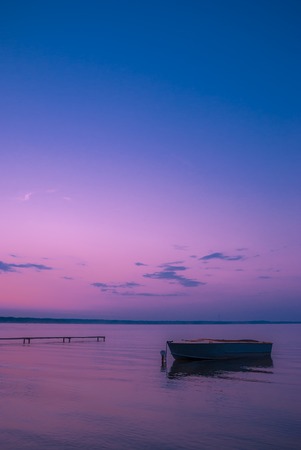boat at the pier and a summer morning on lakeの写真素材