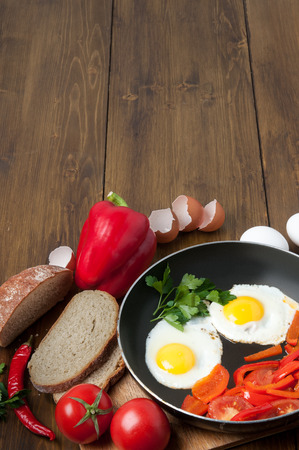 Omelet with bread, tomatoes and bell pepper in skillet pan.の写真素材