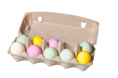 Colorful Easter eggs in a cardboard tray on white backgroundの写真素材