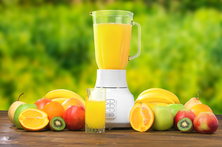 Fresh fruits and glass of juice on rustic wooden tableの写真素材
