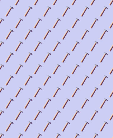 Seamless pattern of old retro hammer isolated on electric blue background - flat layoutの写真素材