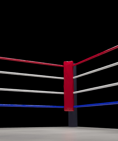 close up of the red corner boxing ring surrounded by ropes isolated on dark backgroundの写真素材