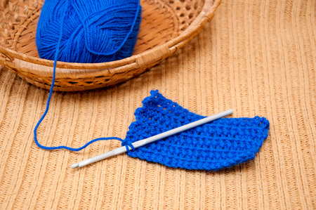 Thread ball in the basket and knitting needleの写真素材