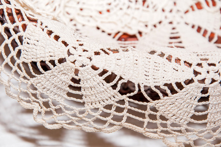 Handmade beige lace doily on the tableの写真素材