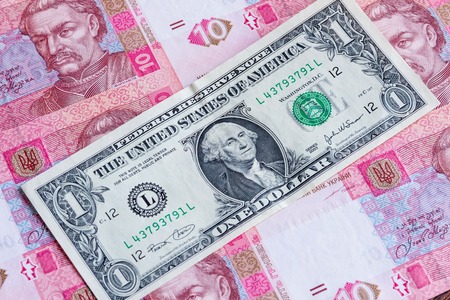 Hryvnia depreciation concept. One american dollar over ukrainian money