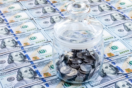 Money save concept. Bank / jar from glass with silver coinsの写真素材