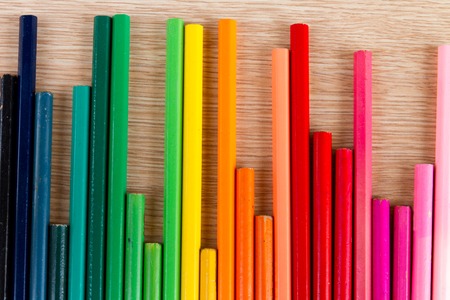 Abstract row of colorful pens on wooden tableの写真素材