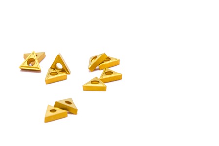 Broken golden lathe tools for heavy industry on white background