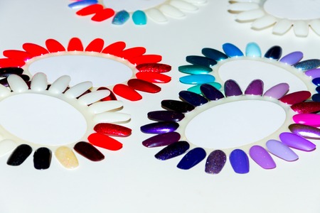 Nail polish palette in form of chamomile. Colorful polishes for nails. Fingers careの写真素材