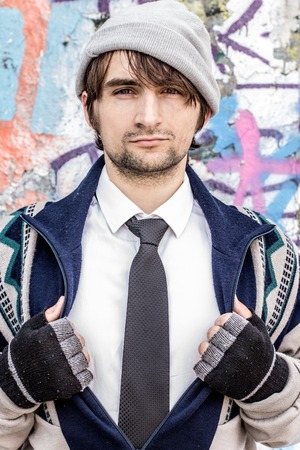 Rich man who lost everything and became homeless standing in suitの写真素材