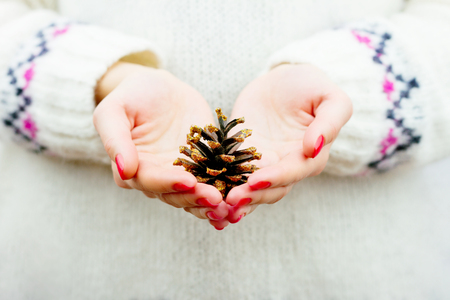 Girl holding cone decorated with gold sparklesの写真素材