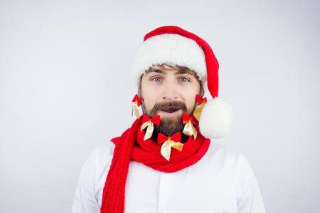 Guy dressed as Santa wearing beard decorated with colorful bowsの写真素材
