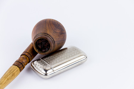 A wooden pipe and a silver lighter isolated on white backgroundの写真素材