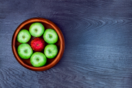 Healthy food. Several apples in the wooden plate isolated on grey background. Making apple pieの写真素材