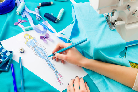 Close up of girls hands drawing a sketch of a costumeの写真素材