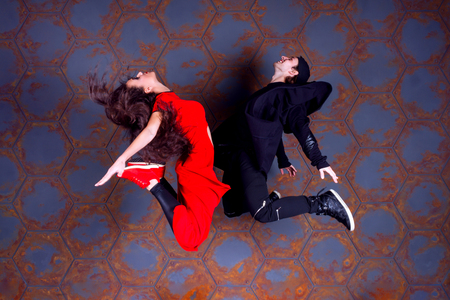 Dancers guy and girl jumping together near the wall. Urban style.の写真素材