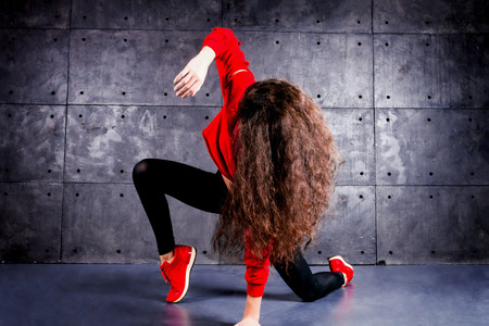 Girl dancing in front of the urban wall.の写真素材