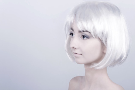 Portrait of young woman / female / girl with white care wig / hair and bare shoulders posingの写真素材