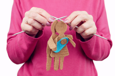Woman female knits silhouette of woman and man in love with newborn baby by knitted needles. Family concept.の写真素材